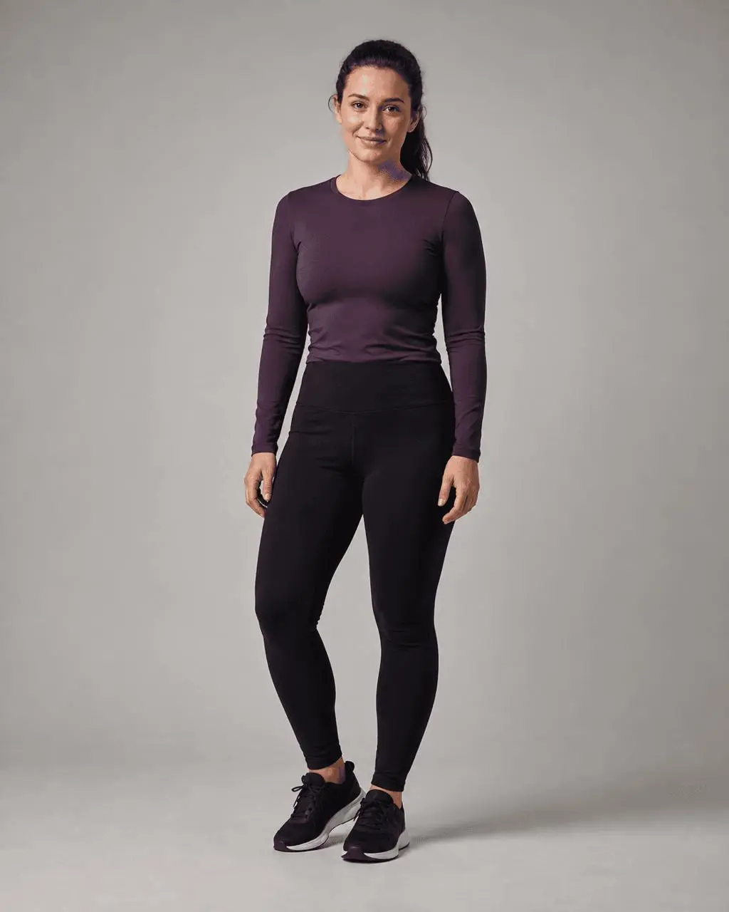 Fully clothed adult woman before an AI breast expansion edit