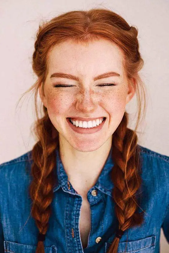Image 1: red-haired woman with braids