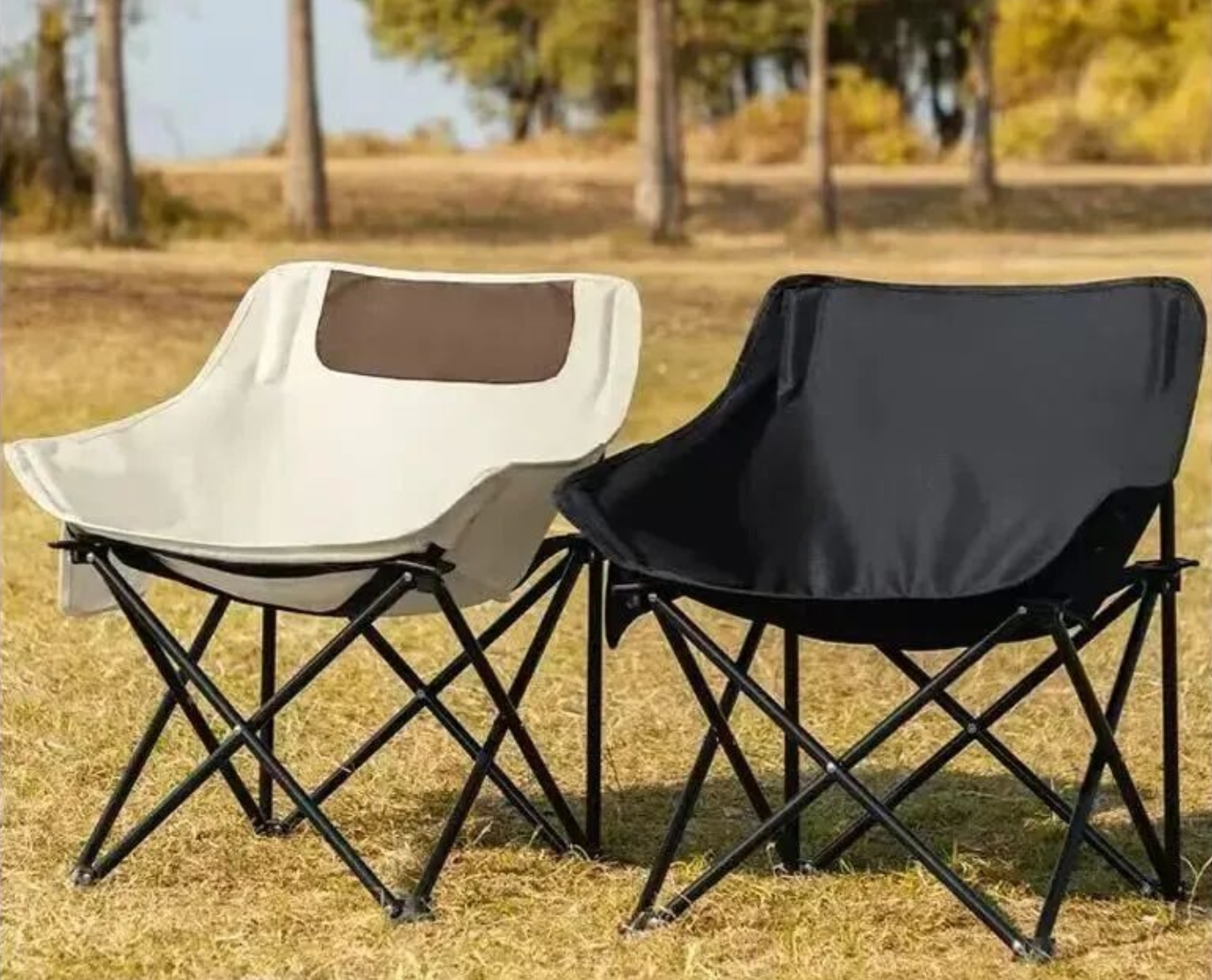 Two folding camping chairs photographed in an outdoor environment