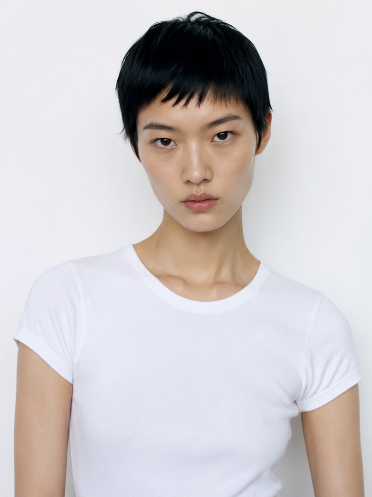 Close portrait of an adult model with short black hair used as the identity reference