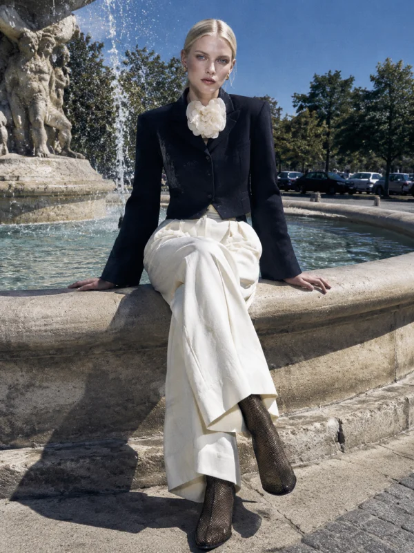 AI-generated stone fountain fashion editorial