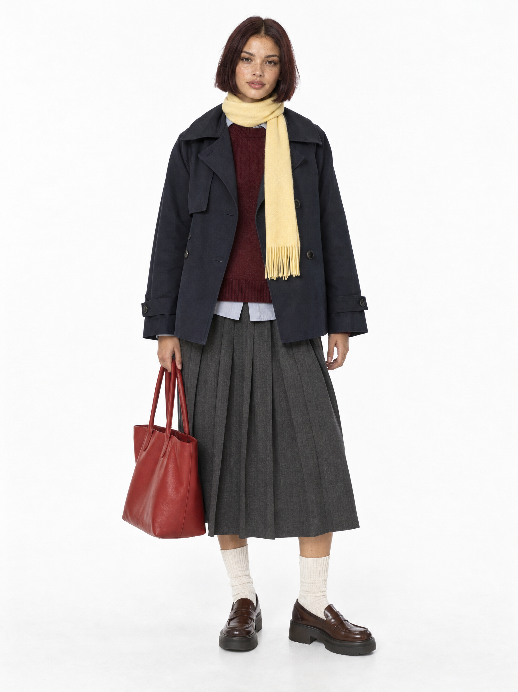 White-background model reference wearing a navy short trench and charcoal pleated skirt
