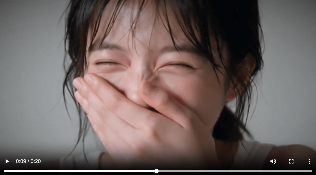 The woman covers her mouth as suppressed laughter breaks through in a Seedance 2.5 micro-expressions video