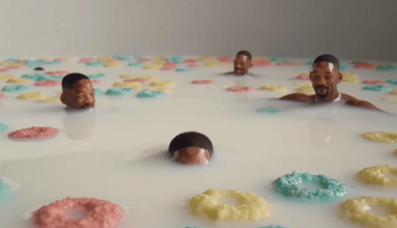 Miniature AI-generated Will Smith figures floating in a giant cereal bowl filled with milk and colorful cereal rings